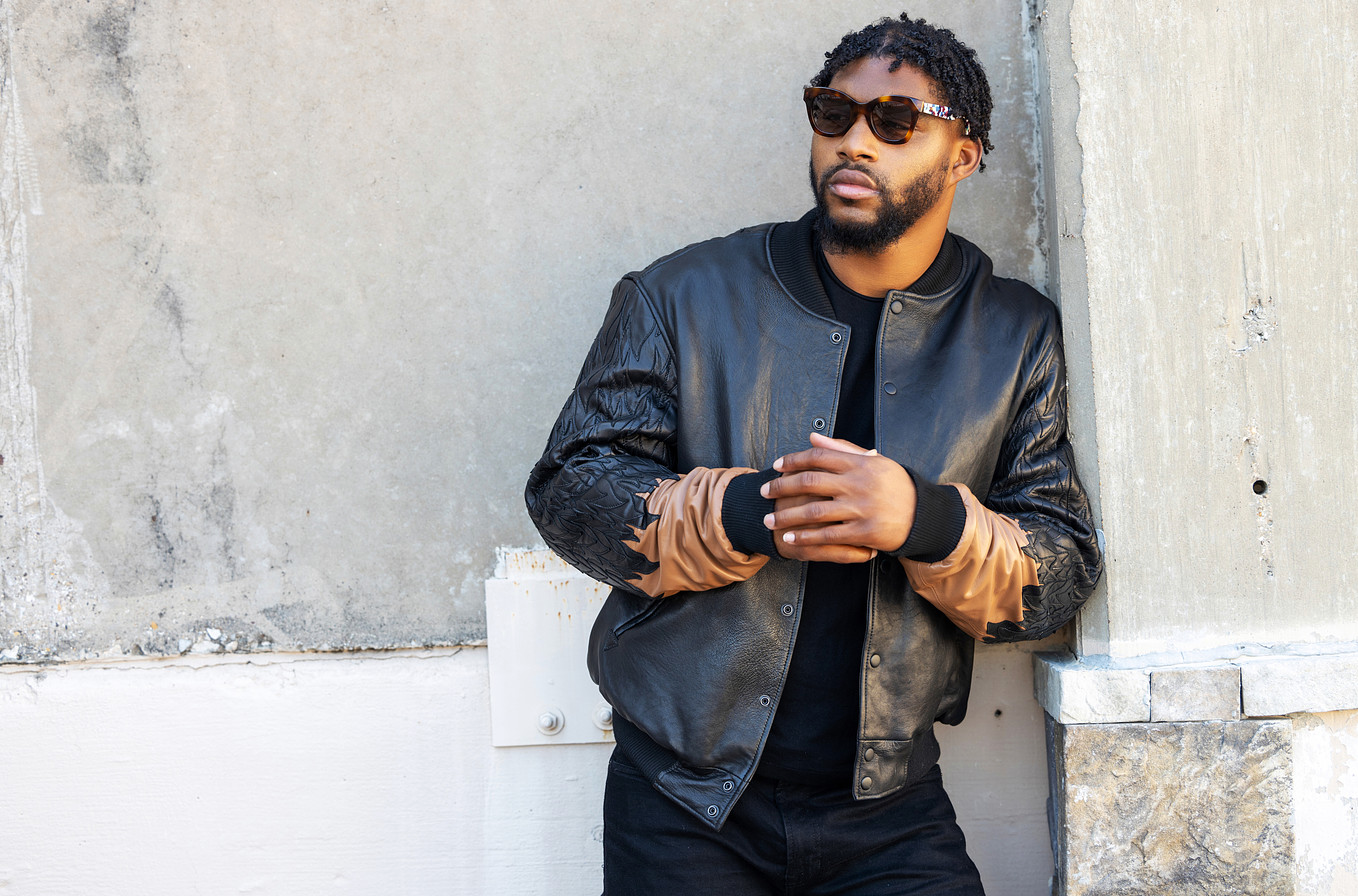 man model wearing a two-toned black and brown leather jacket